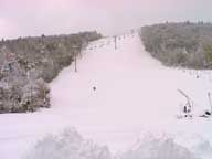 A lone snow boarder hiking up Superstar at Killington after big dump on October 26, 2005