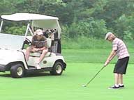 =My brother John watches his son John preparing to rip one at Green Mountain National Golf Course.