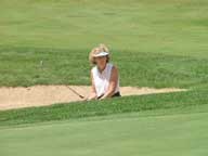 Mary prepares her bunker shot from the front right sand trap on the 15th green at Green Mountain National Golf Course.