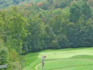 Mary teeing off on the par 3 13th hole at Green Mountain National.  Notice that fall foliage color is starting to appear.