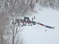 Chevy Snowboarding Grand Prix Competitors wait their turn on Bear Claw below the Viper Pit at Bear Mountain.