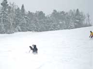 Snow snake captures Howie at Pico.  Notice Walt skiing into frame right with powder almost to his knees.