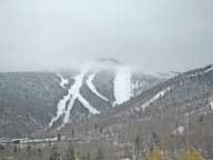 Snowmaking operations taking place on upper trails of Killington Peak