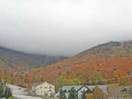 Fall color at base of cloud covered Killington Peak