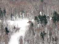 Snow grooming machine on Dream Maker building terrain park.