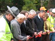 Vermont Governor Peter Shumlin flanked by VT Commissioner of Tourism Megan Smith and Killington Resort President Chris Nyberg cut the ribbon to re-open Route 4 for traffic in Killington.