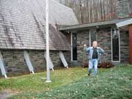 Bill wrapping the flag pole in front of the Birch Ridge Inn with lights for the winter.