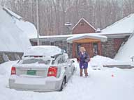 Mary sculpting snow off of her car at Birch Ridge