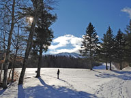 Mary walking the Killington Golf Course with Skye Peak in the background