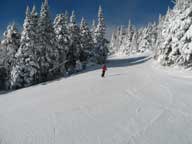 Mary traversing between Killington Peak and Bear Mountain in beautiful sunshine.