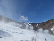 Snowmaking on Superstar with Killington Peak in the background.